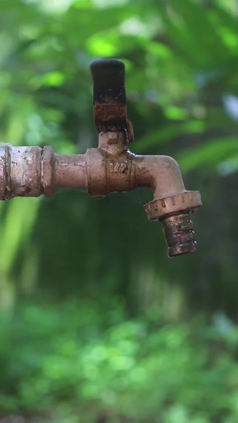 Water dripping from an old rusty tap Stock Footage