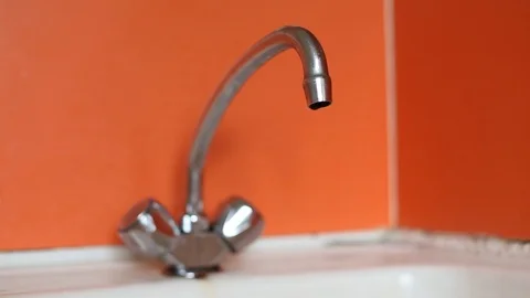 Water dripping from the old tap close-up. Water running out broken water tap Stock Footage 92378587