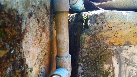 Water dripping from the pipe in a constant stream Stock Footage 251412477