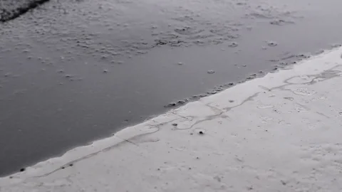 Water dripping in puddle Stock Footage 76563321