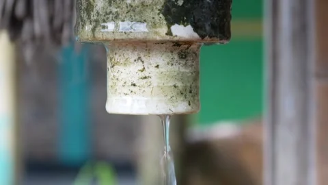 Water dripping from a tap or pipe Stock Footage 304773454