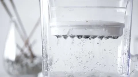 Water dripping through a filter with big drops on relaxing background Stock Footage 159443253