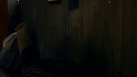 Water drips down in a dark room Stock-Footage 80044619