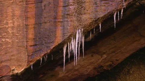 Water drips from icicles on oxidized cliff in Zion NP UT USA Stock Footage 339908534