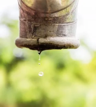 Water drips from a pipe. Stock Photos