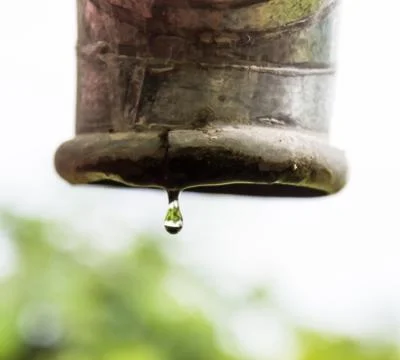 Water drips from a pipe. Stock Photos