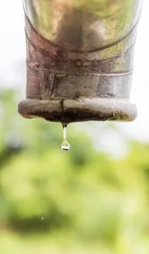 Water drips from a pipe. Stock Photos