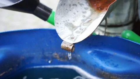 Water drips from a rain gutter into a water barrel Stock Footage 119442788