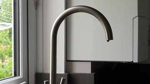 Water drips slowly from kitchen mixer tap. Stock Footage 244925506