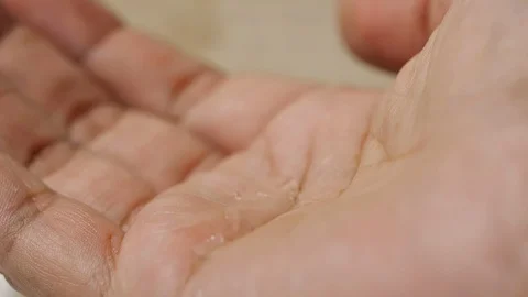 Water drop and splash into the men hand in slow motion Stock-Footage 113594228