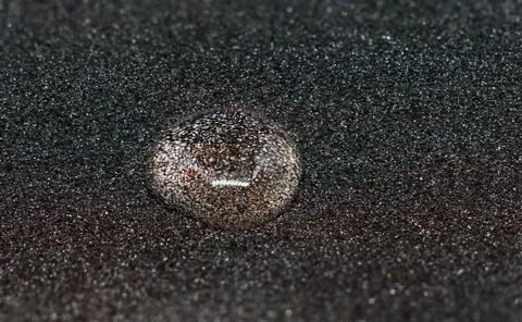 Water drop black background. Stockfoto's