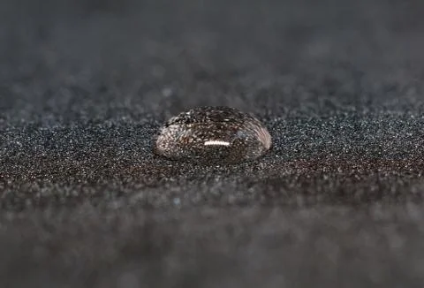 Water drop black background. Stock Photos