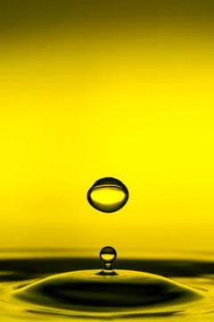 Water drop bouncing back from the surface,creating mesmerizing ripples,while 스톡 사진