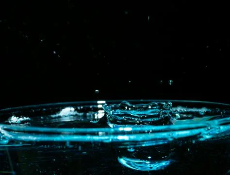 Water drop closeups while drops falling down and splashing into water in Jena Stock Photos
