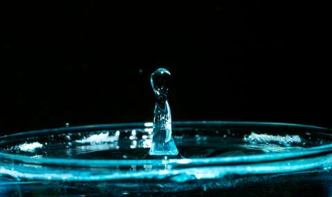 Water drop closeups while drops falling down and splashing into water in Jena Stock Photos