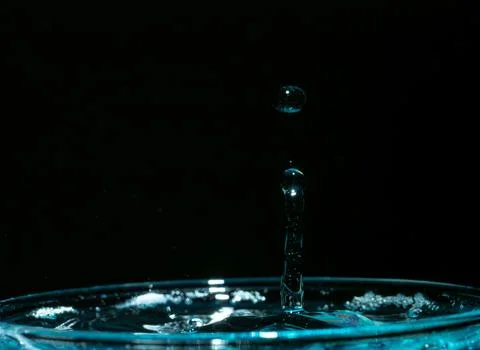 Water drop closeups while drops falling down and splashing into water in Jena Stock Photos