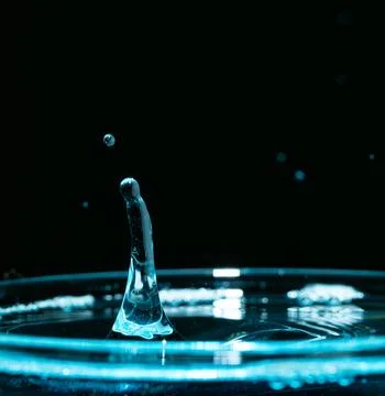 Water drop closeups while drops falling down and splashing into water in Jena Stock Photos