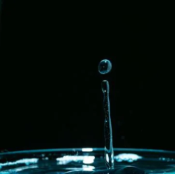 Water drop closeups while drops falling down and splashing into water in Jena Stock Photos