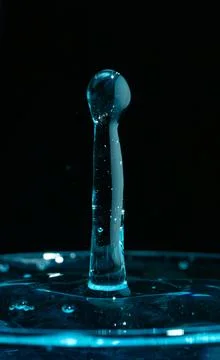 Water drop closeups while drops falling down and splashing into water in Jena Stock Photos