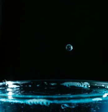Water drop closeups while drops falling down and splashing into water in Jena Stock Photos
