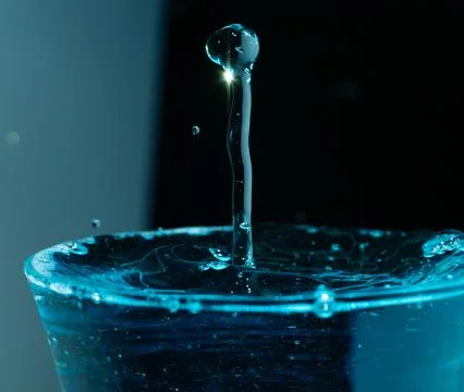Water drop closeups while drops falling down and splashing into water in Jena Stock Photos