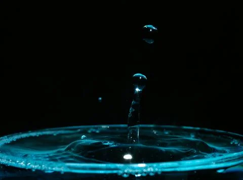 Water drop closeups while drops falling down and splashing into water in Jena Stock Photos