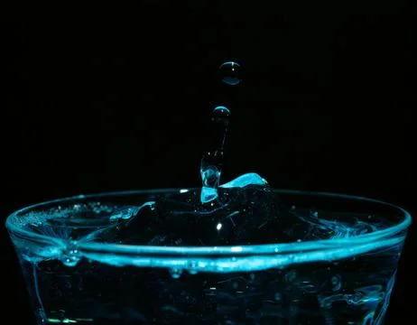 Water drop closeups while drops falling down and splashing into water in Jena Stock Photos