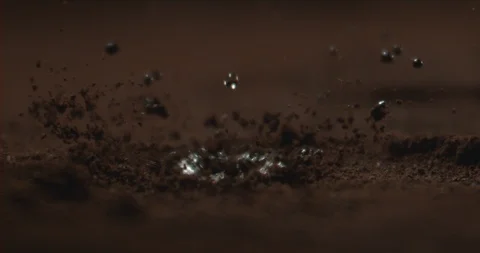 Water drop onto coffee powder in slow motion Stock Footage