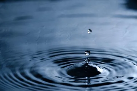 Water drop dripping Stock Photos