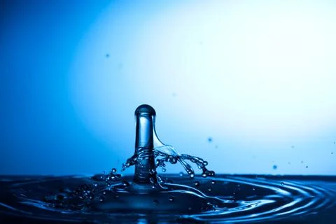 Water drop falling and colliding Stock Photos