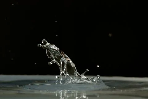 Water drop falling and colliding Stock Photos