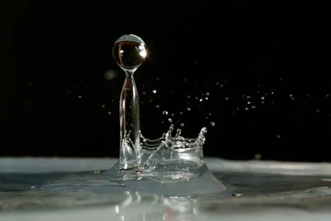 Water drop falling and colliding Stock Photos