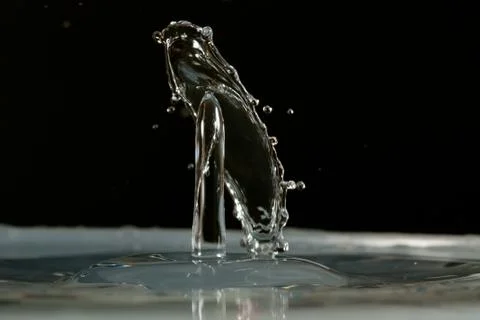 Water drop falling and colliding Stock Photos
