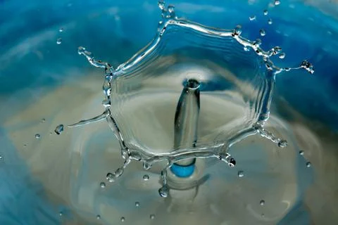Water drop falling and colliding Stock Photos