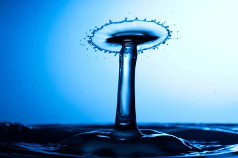 Water drop falling and colliding Stock Photos