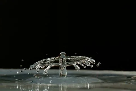 Water drop falling and colliding Stock Photos