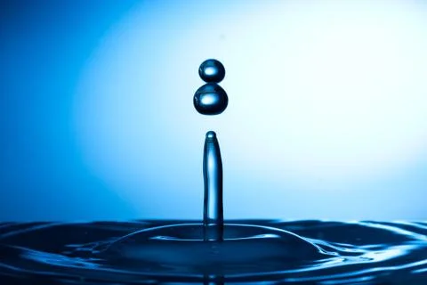 Water drop falling and colliding Stock Photos