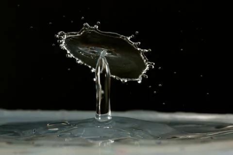 Water drop falling and colliding Stock Photos