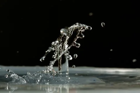Water drop falling and colliding Stock Photos