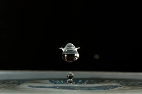 Water drop falling and colliding Stock Photos