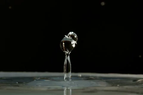 Water drop falling and colliding Stock Photos