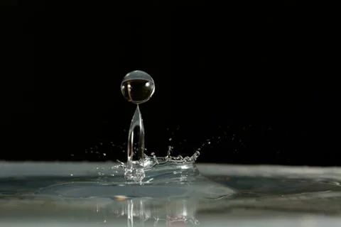 Water drop falling and colliding Stock Photos
