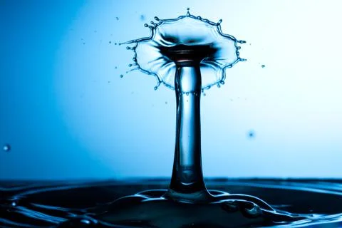 Water drop falling and colliding Stock Photos