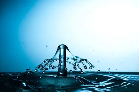Water drop falling and colliding Stock Photos