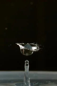 Water drop falling and colliding Stock Photos