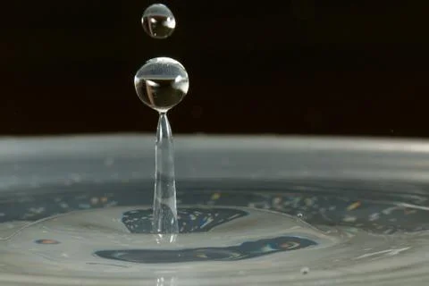 Water drop falling and colliding Stock Photos