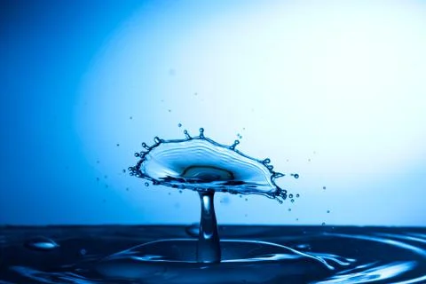 Water drop falling and colliding Stock Photos