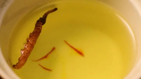 Water Drop Falling into Cordyceps Tea in Slow Motion Close Up Stock Footage 340450483