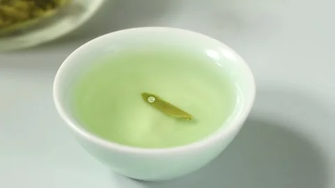 Water Drop Falling Into Green Tea Cup in Slow Motion Macro Close Up 動画素材 340617241