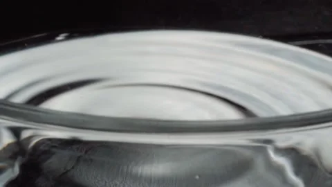 Water Drop Falling into Liquid Creating Circular Ripples in Slow Motion Close Up Stock Footage 339763641